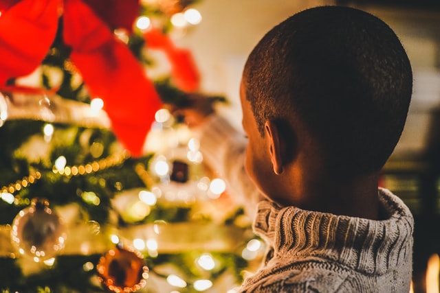 photo of child decorating the Christmas tree